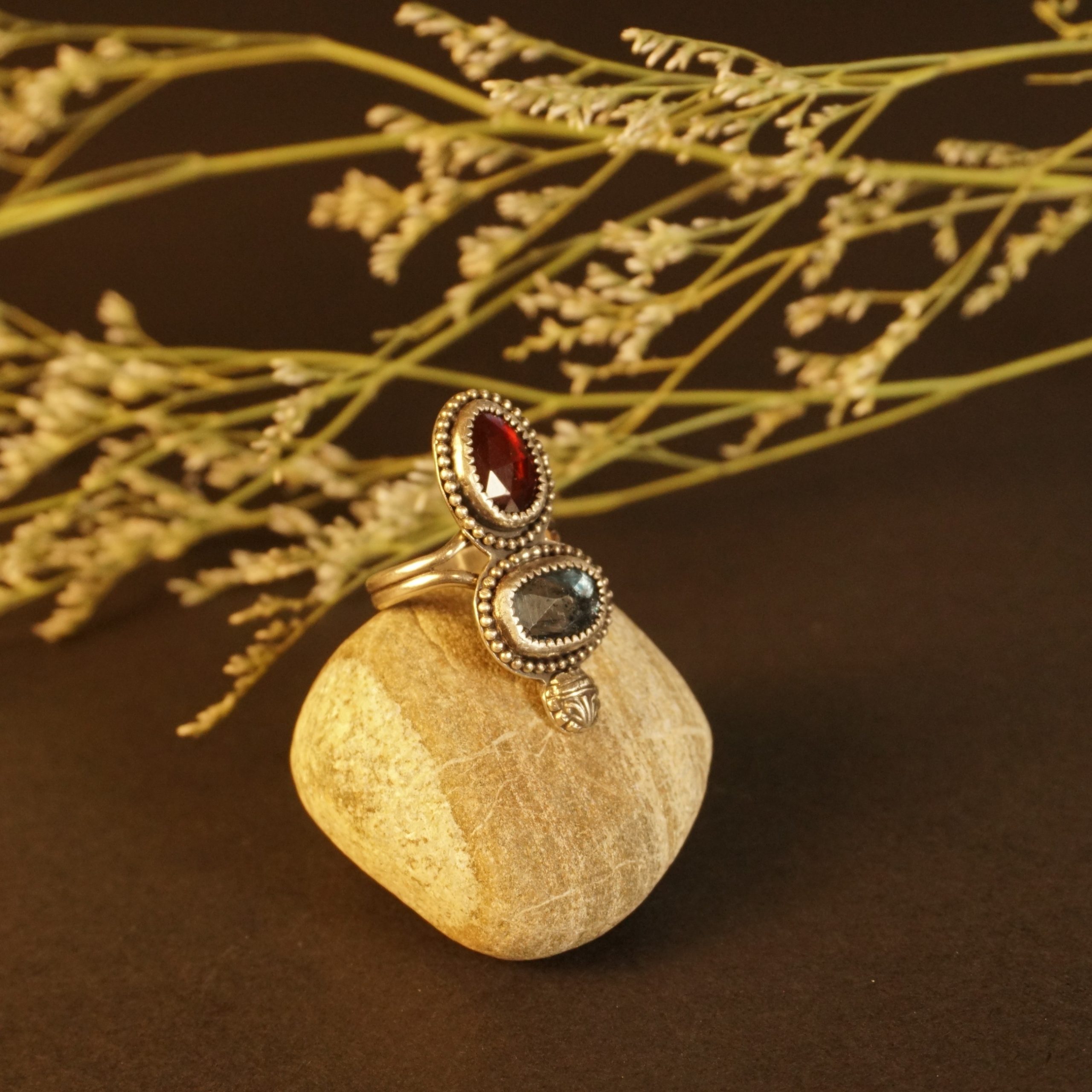 Right side view of Crown & Embers artisan sterling silver ring with hessonite garnet and blue kyanite gemstones