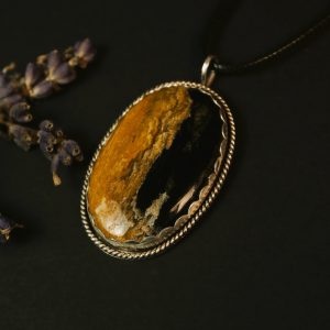 Palm root agate pendant flat lay hero shot showing natural root patterns