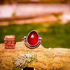 terling silver Hessonite Garnet ring with a bezel-set gemstone in warm orange-red hues, featuring a split shank and double band design for a dainty and elegant look.