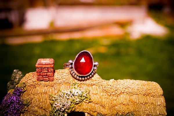 terling silver Hessonite Garnet ring with a bezel-set gemstone in warm orange-red hues, featuring a split shank and double band design for a dainty and elegant look.