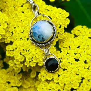 Handcrafted moonstone and gold obsidian pendant set in sterling silver, showcasing a beautiful blue hue and golden sheen, symbolizing protection and inspiration