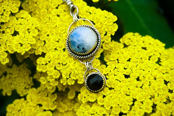 Handcrafted moonstone and gold obsidian pendant set in sterling silver, showcasing a beautiful blue hue and golden sheen, symbolizing protection and inspiration