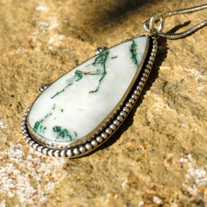 Handmade Tree Moss Agate pendant in sterling silver with green patterns and spooky cut-out detail