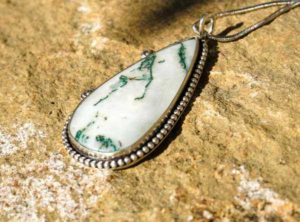 Handmade Tree Moss Agate pendant in sterling silver with green patterns and spooky cut-out detail