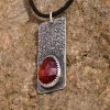 Right angle of rose-cut Garnet set in sterling silver bezel