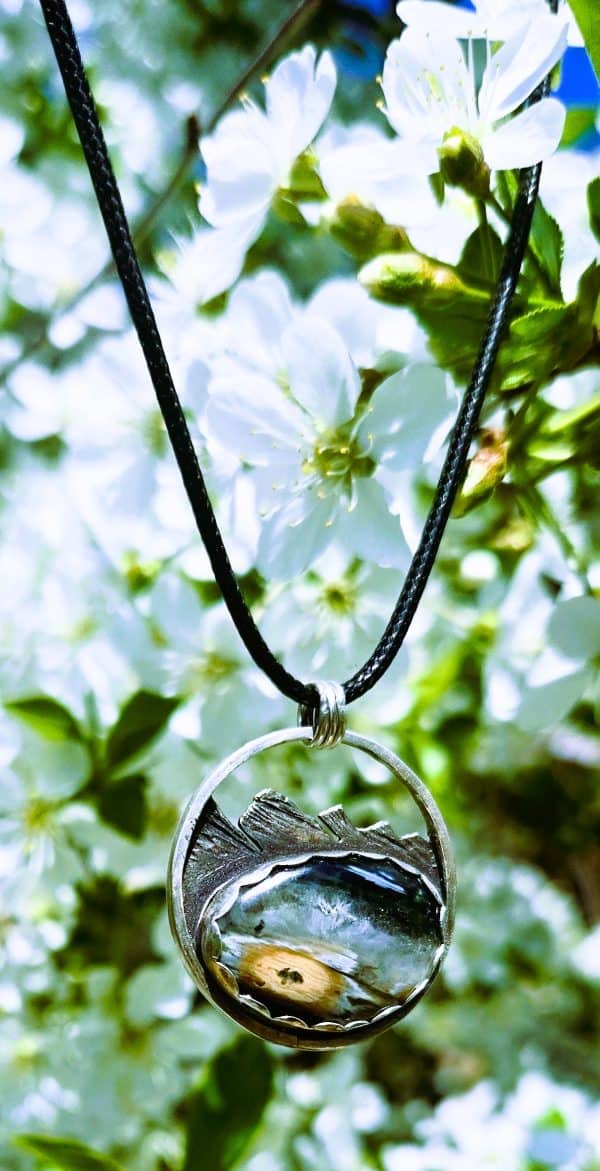 Pendant hanging from tree with flower background