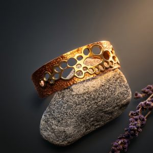 Right side view of Copper Lace hand-textured brass and copper cuff bracelet showing mixed metal detail and hammered finish