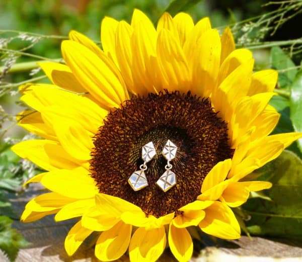 Sterling Silver Geometric Link Drop Stud Earrings displayed on sunflower