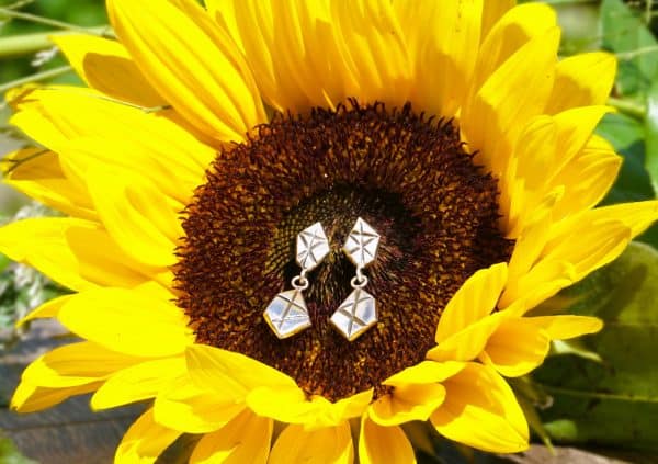 Stud Earrings displayed on sunflower for natural jewelry photography