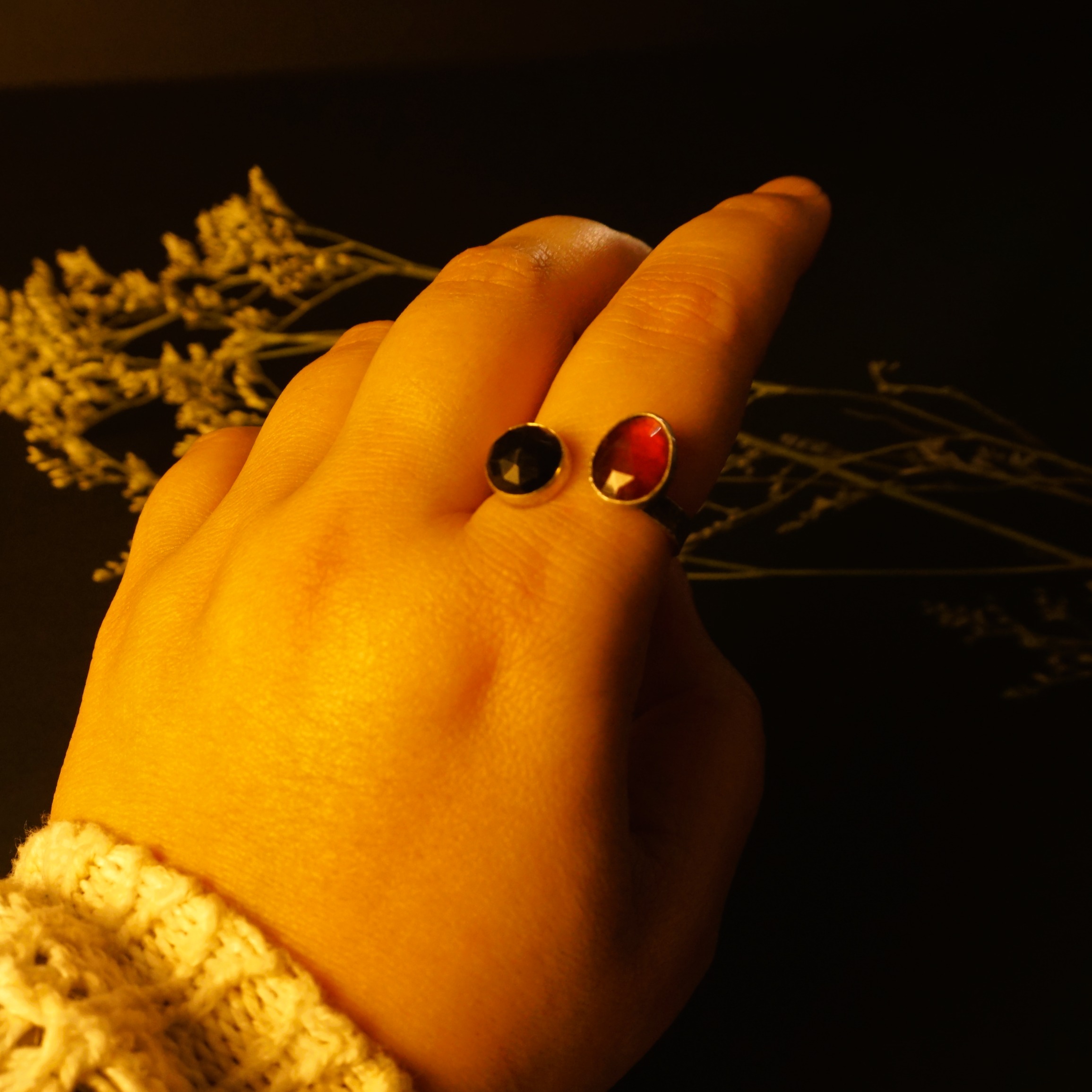 Solar Flare Ring – garnet obsidian silver ring on hand, bright light