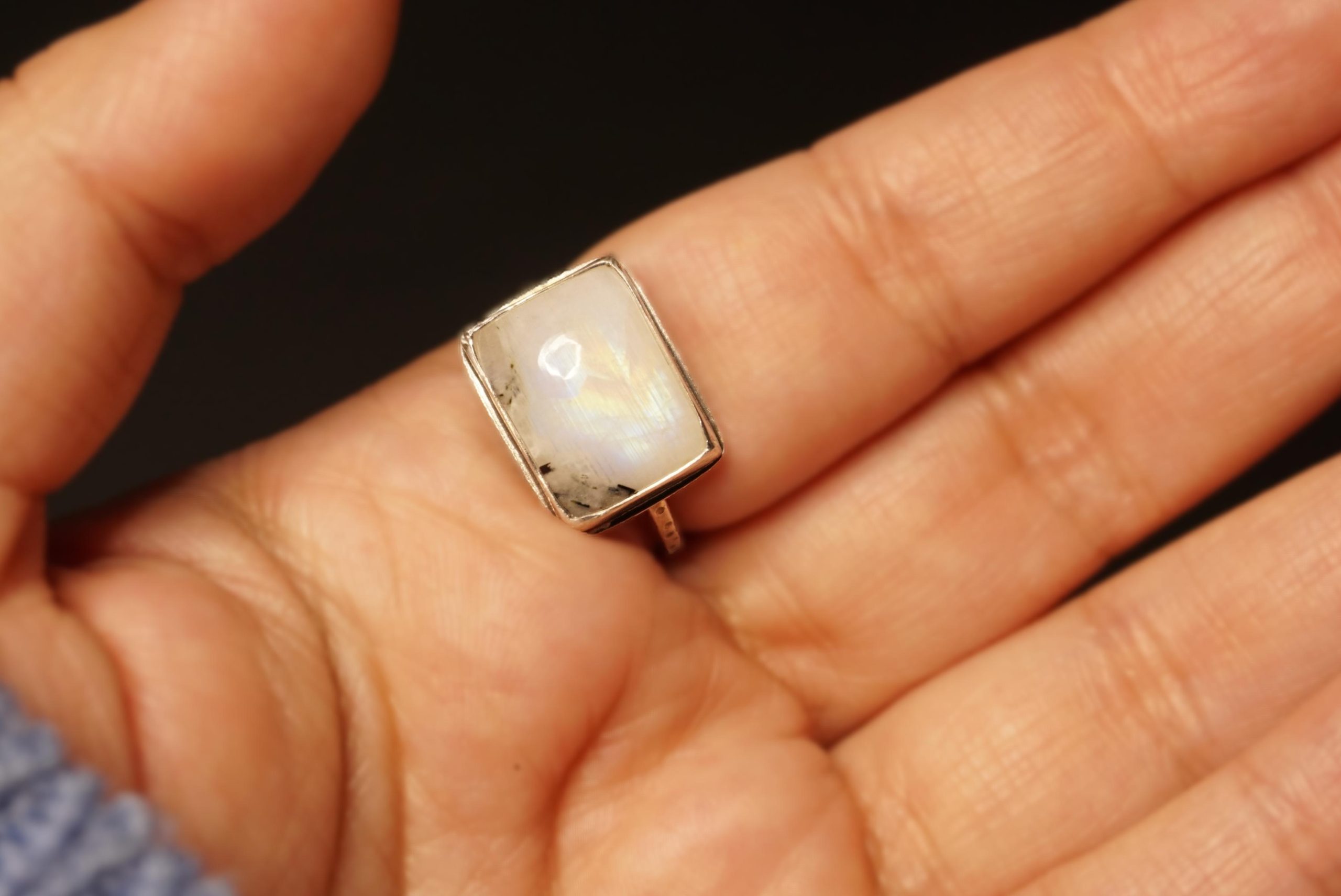 Square moonstone silver ring close-up, palm view