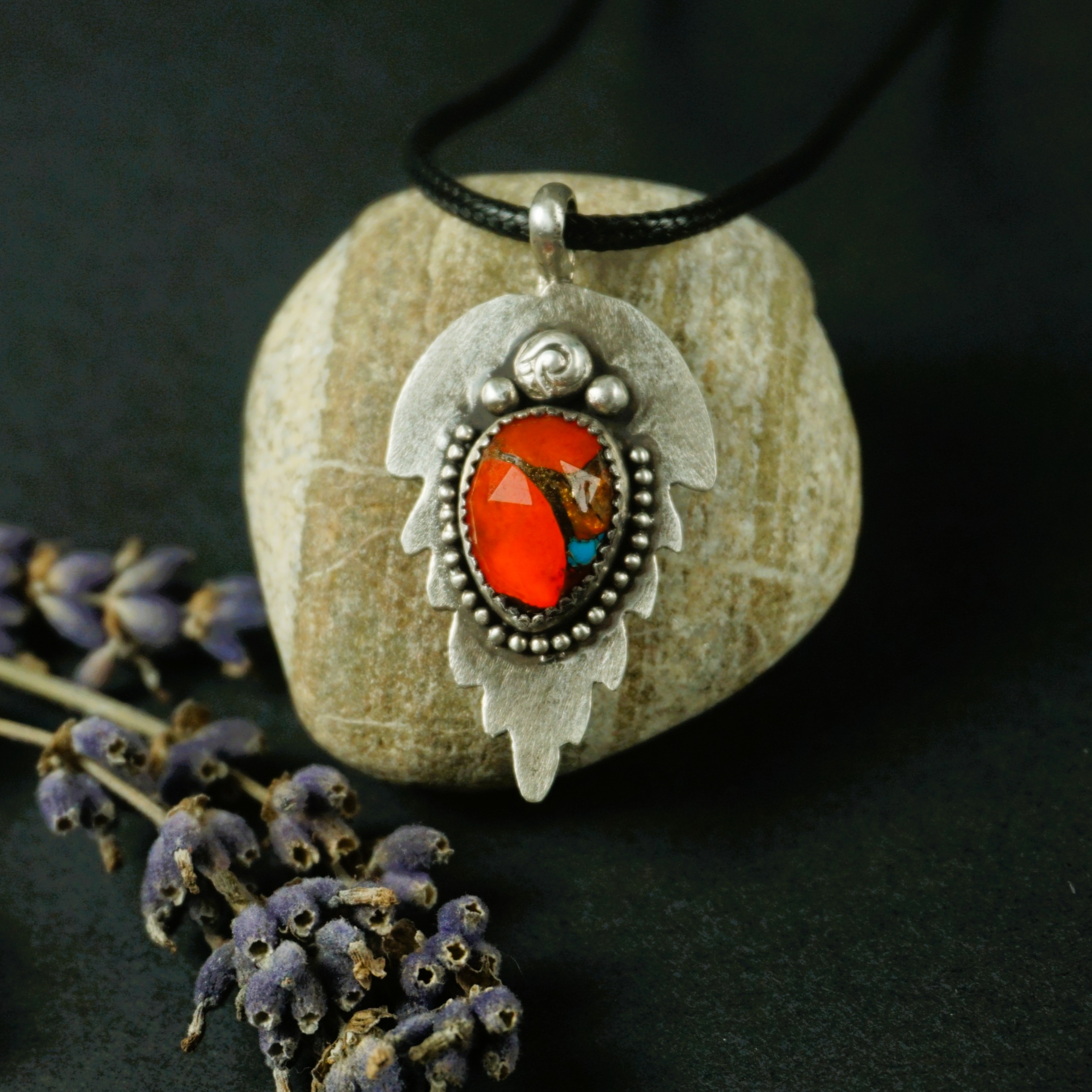 ilver Leaf Pendant Necklace with orange and turquoise composite stone in sterling silver, leaf-shaped textured backplate, beaded edges, photographed under cool blue-toned lighting