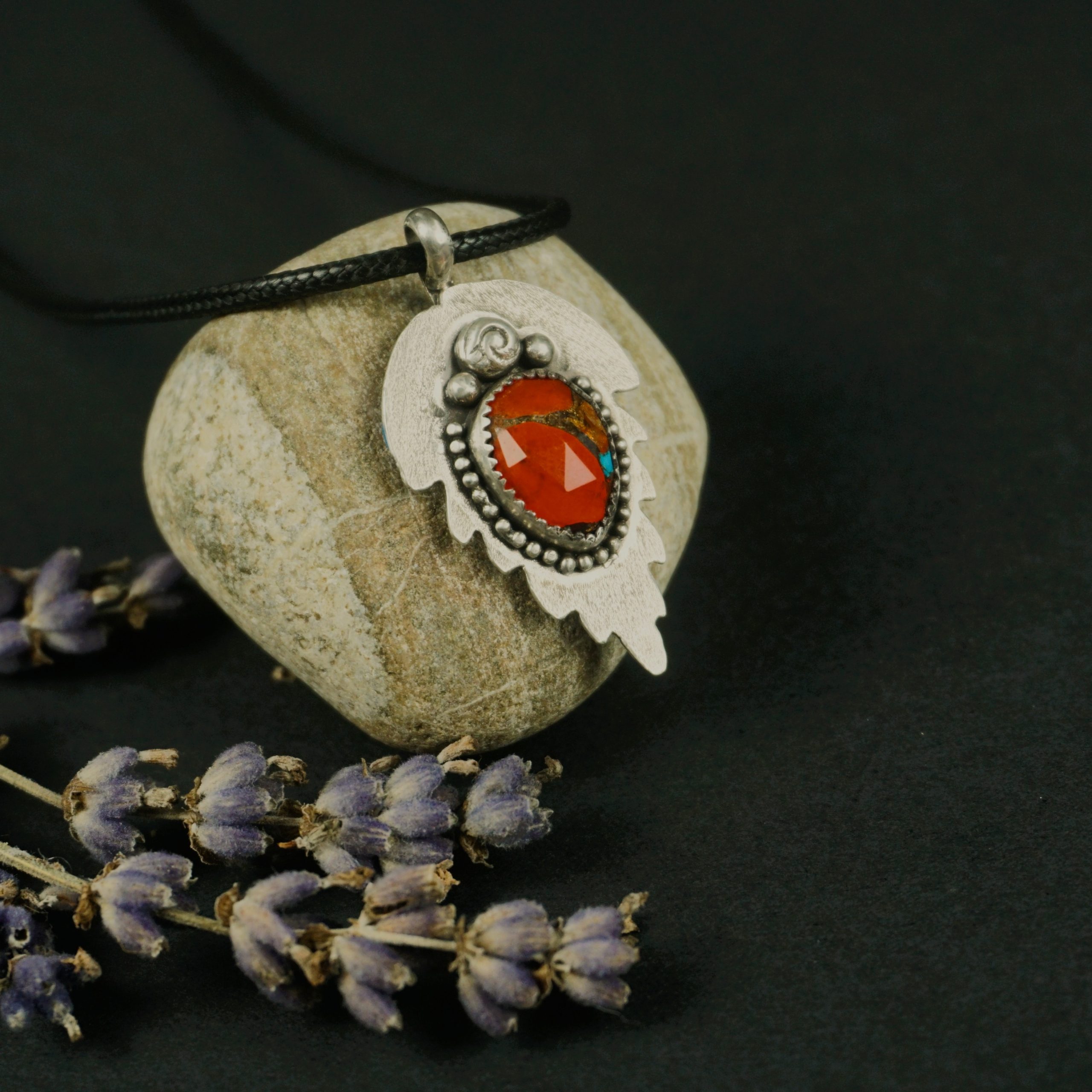 Right side view of Solstice Leaf Pendant Necklace, showcasing vibrant orange and turquoise composite stone, handcrafted silver leaf-shaped backplate with beaded edges and top accents