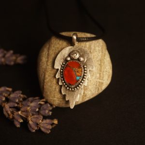 Silver Leaf Pendant Necklace with orange and turquoise composite stone, bezel set in sterling silver, leaf-shaped textured backplate with beaded edges, photographed under warm golden lighting