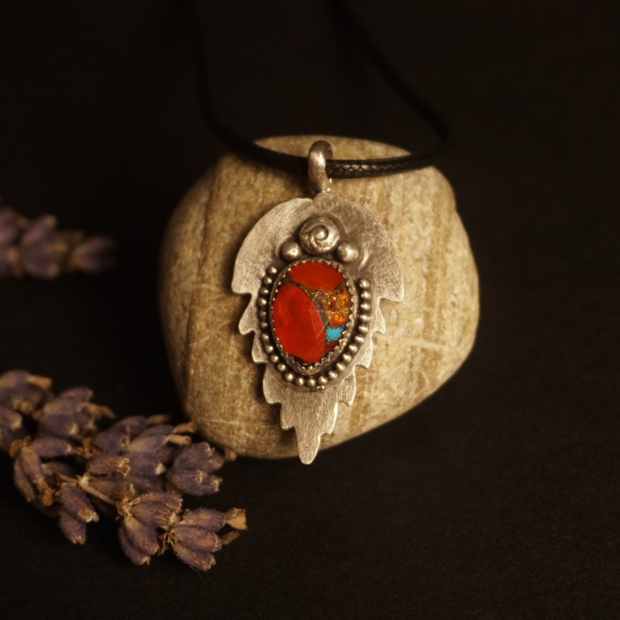 Silver Leaf Pendant Necklace with orange and turquoise composite stone, bezel set in sterling silver, leaf-shaped textured backplate with beaded edges, photographed under warm golden lighting