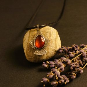rimson Empress pendant garnet in warm lighting, highlighting rich red tones